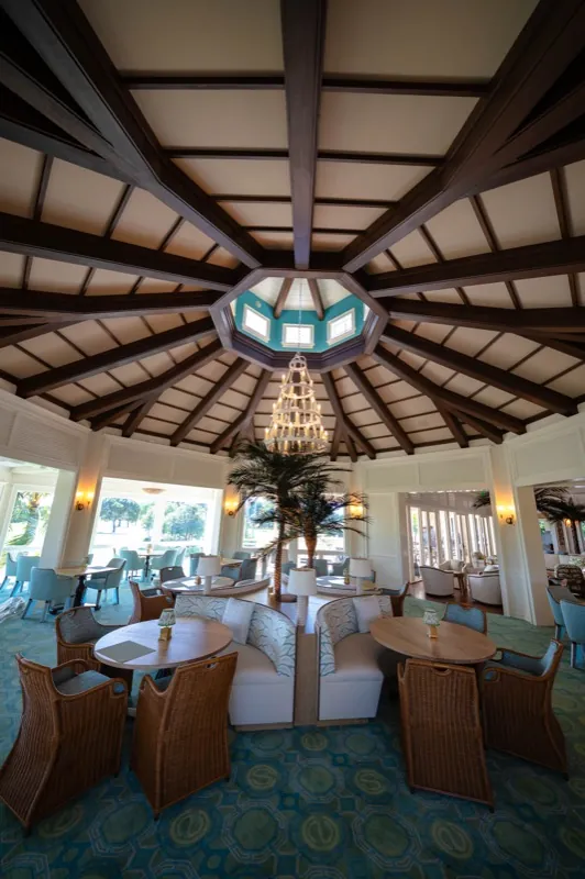 Card Sound Clubhouse lounge with a vaulted tropical-beam ceiling and brass chandelier