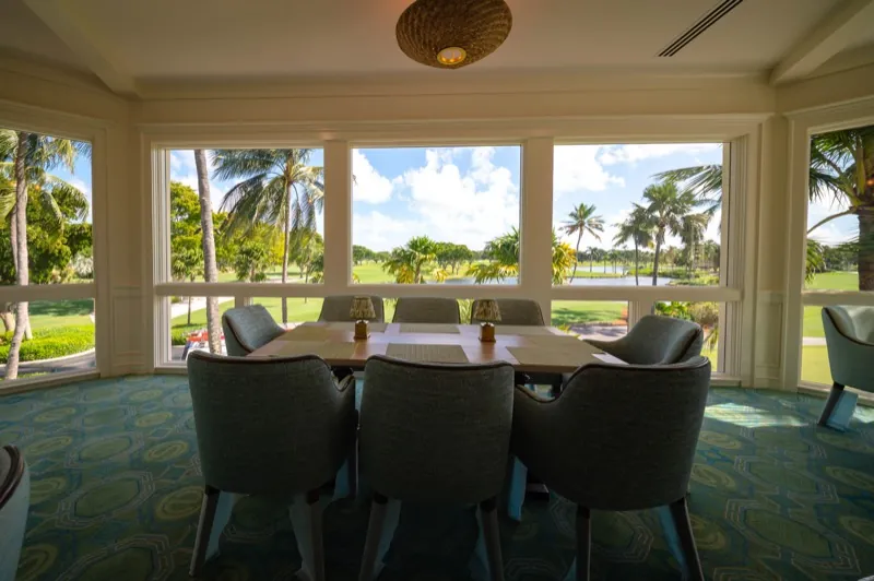 Card Sound Clubhouse dining nook with a round table and golf course view