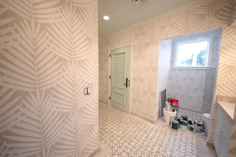 Card Sound Clubhouse bathroom hallway with palm-leaf pattern wallcovering, installed by Wallcovering Pro