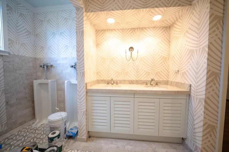 Card Sound Clubhouse vanity nook with palm-leaf pattern wallcovering, installed by Wallcovering Pro
