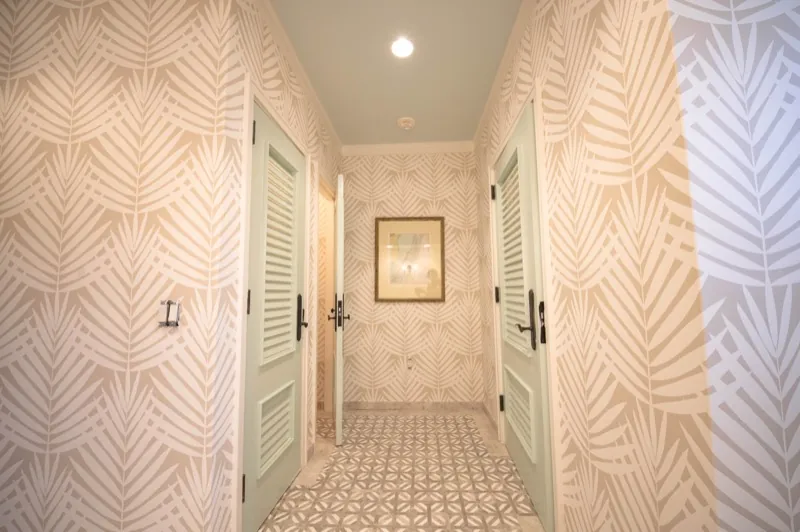 Card Sound Clubhouse hallway with palm-leaf pattern wallcovering, installed by Wallcovering Pro
