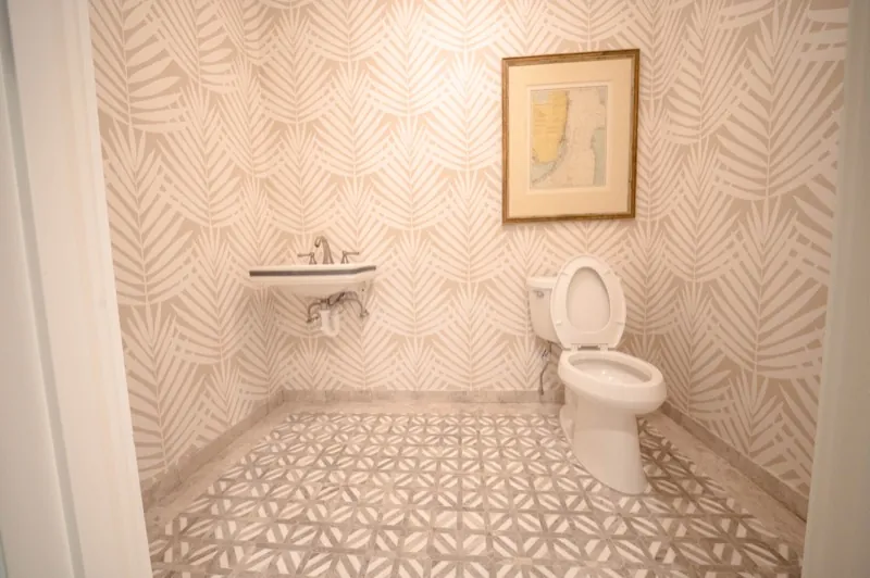 Card Sound Clubhouse powder room with palm-leaf pattern wallcovering, installed by Wallcovering Pro