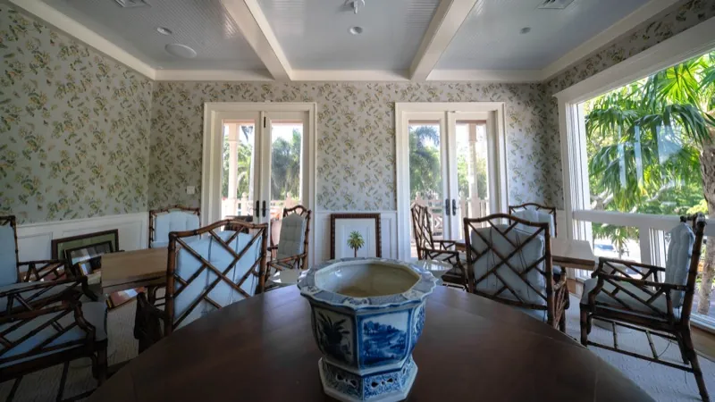 Card Sound Clubhouse porch dining room with floral wallpaper, installed by Wallcovering Pro
