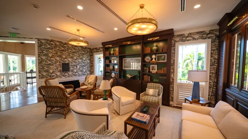 Card Sound Clubhouse library lounge with a textured stone-look wallcovering accent wall, installed by Wallcovering Pro