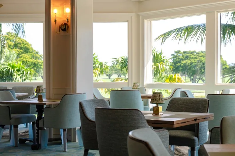 Card Sound Clubhouse sunroom seating with a golf course view