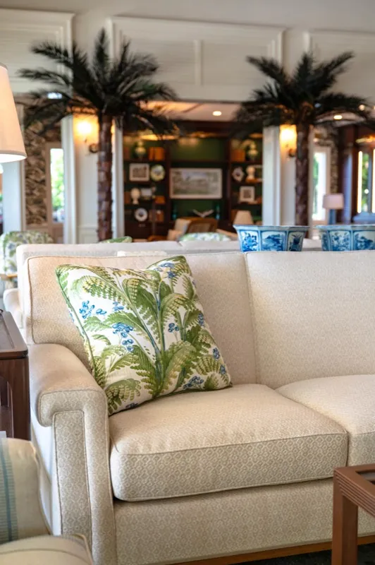 Card Sound Clubhouse sofa detail with a tropical leaf-print throw pillow